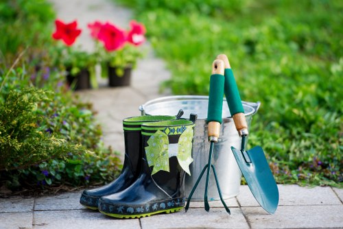 Gardening team overview with tools and PPE in residential garden