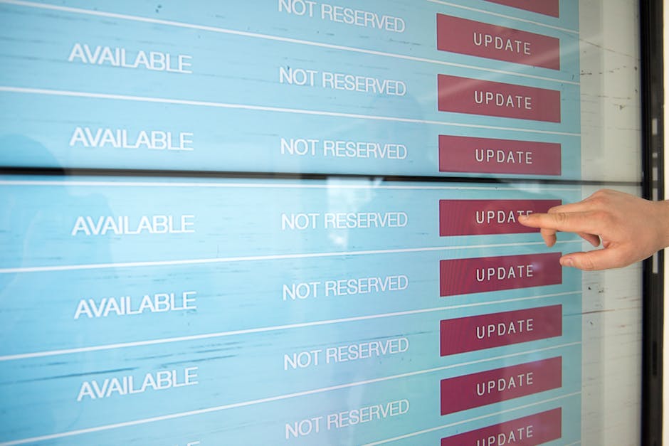 A person with a light skin tone and neatly trimmed fingernails is pressing a red 'Update' button on a digital interface displaying scheduling slots for gardening services. The screen shows multiple ro